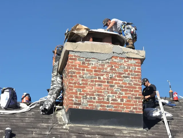 Burrillville Chimney Sweep installing a custom chimney crown in Burrillville, RI